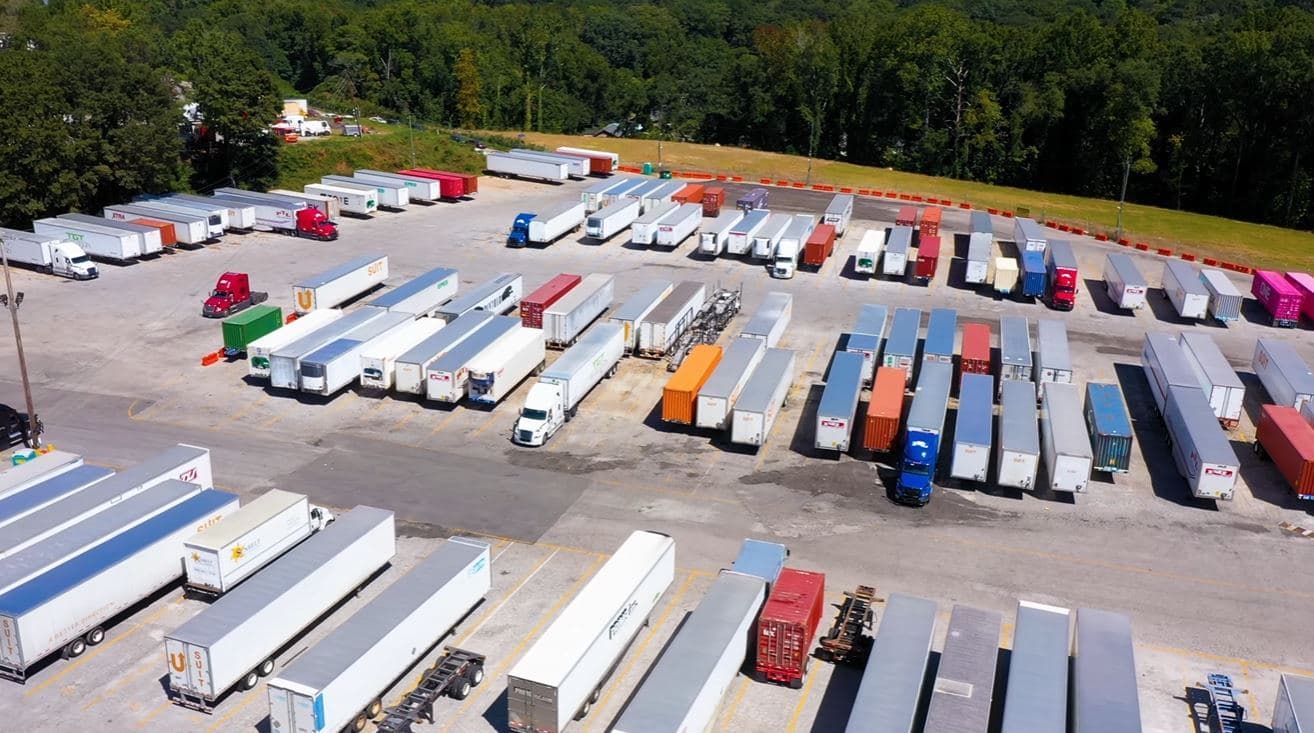 Aerial view of the Store My Truck yard on Jonesboro Rd SE in Atlanta, Georgia: rows of trailers and tractors on a paved, striped lot.