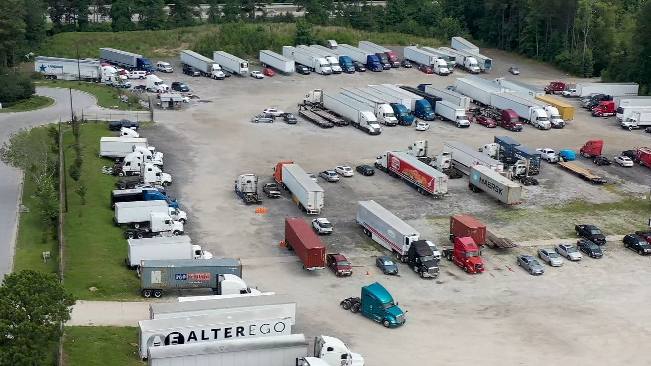 Aerial view of the Store My Truck yard on Brumbley Ct in Union City, Georgia: tractors, trailers, containers and cars across a gravel lot.